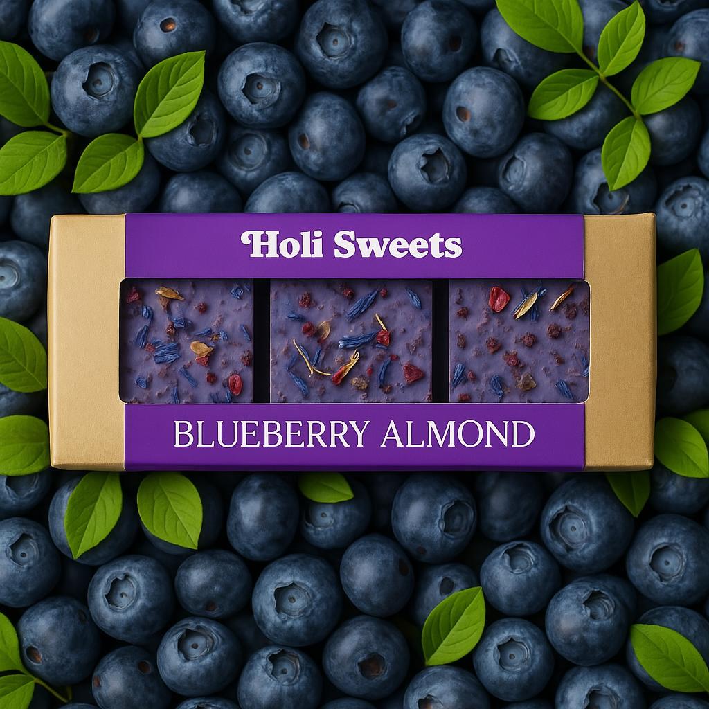 Holi Sweets Blueberry Almond vegan dessert box surrounded by fresh blueberries and bright green leaves, featuring gluten-free, dairy-free bars with dried fruits and flowers in eco-friendly packaging – vibrant plant-based treat from Munich