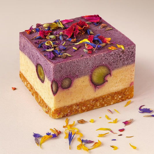 vegan blueberry almond dessert from Holi Sweets with flower topping, gluten-free, dairy-free, sugar-free treat.