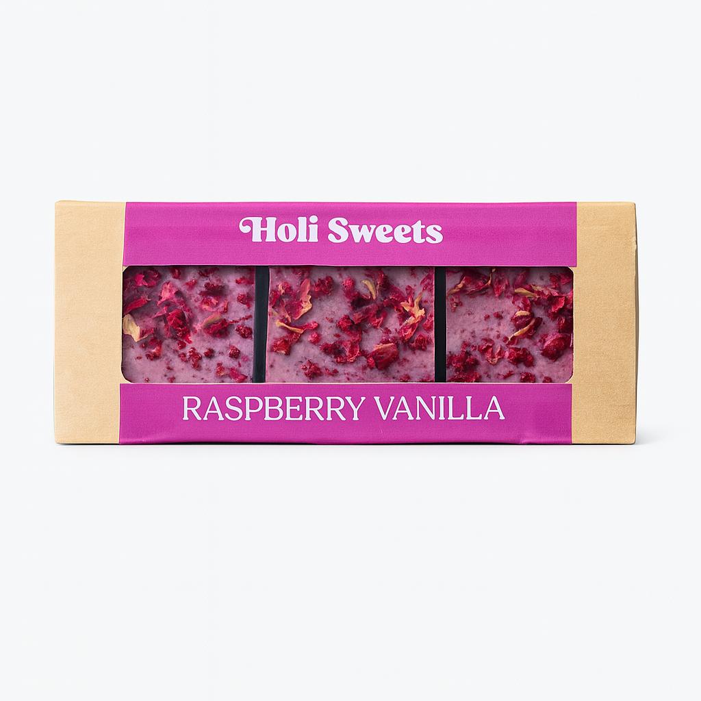 Holi Sweets Raspberry Vanilla vegan dessert box with three handmade, gluten-free, dairy-free raspberry bars topped with rose petals in eco-friendly packaging – elegant healthy treat from Munich