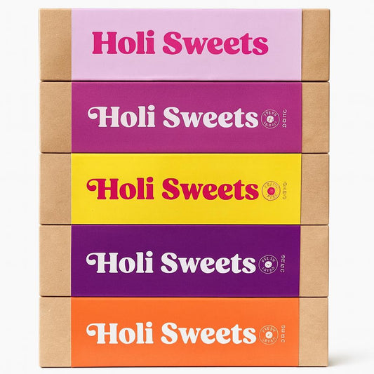 Stack of five colorful Holi Sweets vegan dessert boxes including Strawberry Lime, Raspberry Vanilla, Lemon Kiss, Blueberry Almond, and Tiramisu – gluten-free, refined sugar-free gift box with eco-friendly packaging from Munich
